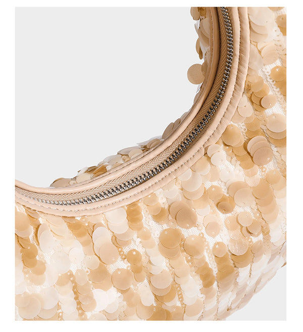 Slouchy crescent hobo shoulder bag covered in overlapping reflective sequin discs with a single integrated strap and top-zip