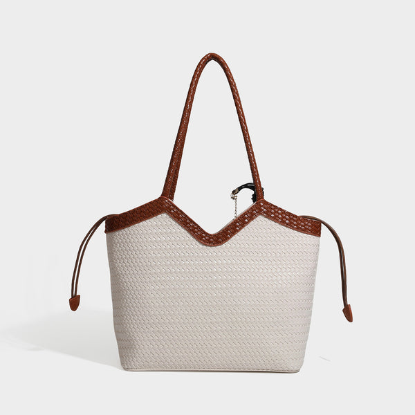 Woven tote bag with braided shoulder straps, drawstring closure, and dangling metal-and-bead charm, detail view 3