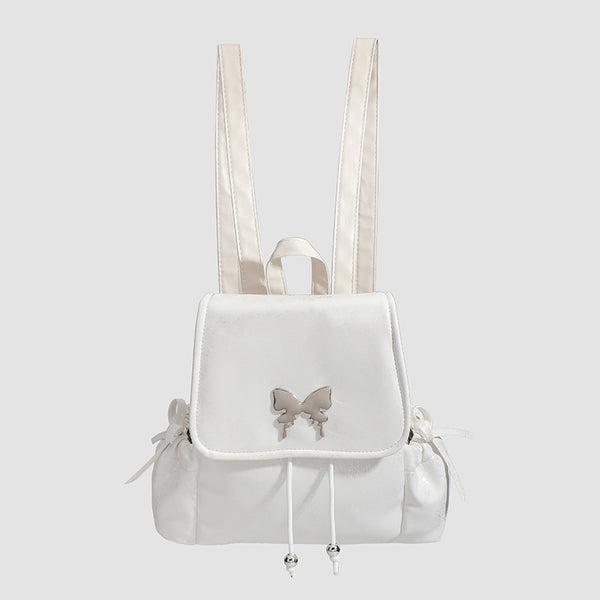 Compact white pearlescent flap backpack with silver-tone bow hardware and drawstring closure, detail view 2