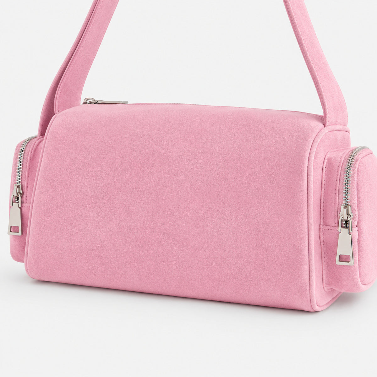 Mini barrel shoulder bag with side zip pouches and adjustable strap in pink suede-like finish, detail view 3