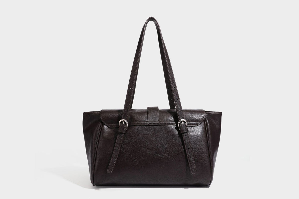 Large structured vintage-style tote bag with flap-front turn-lock closure, twin buckle straps, and double shoulder handles