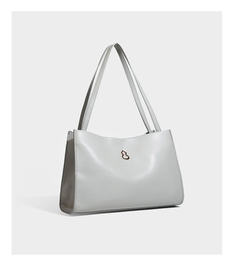 Structured rectangular shoulder tote bag with smooth leather-look finish, long double straps, and gold-tone gourd emblem on