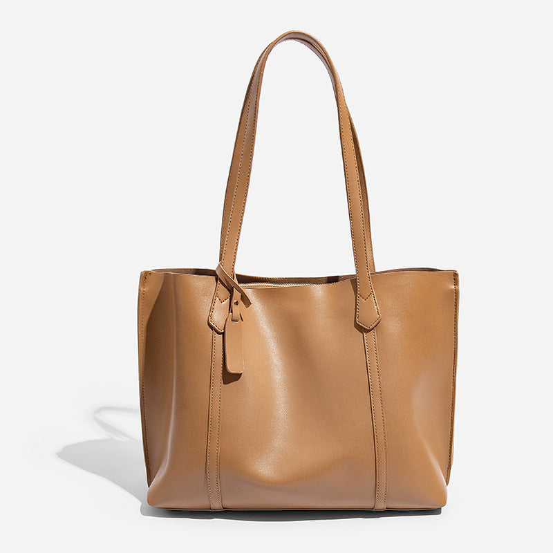 Large structured leather-look tote bag with belt-strap detail and gold-tone hardware, detail view 6