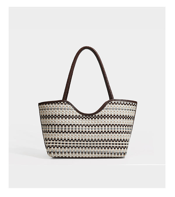 Large woven checker-pattern tote bag with dark braided shoulder straps, leather-look trim, and drawstring side ties, detail