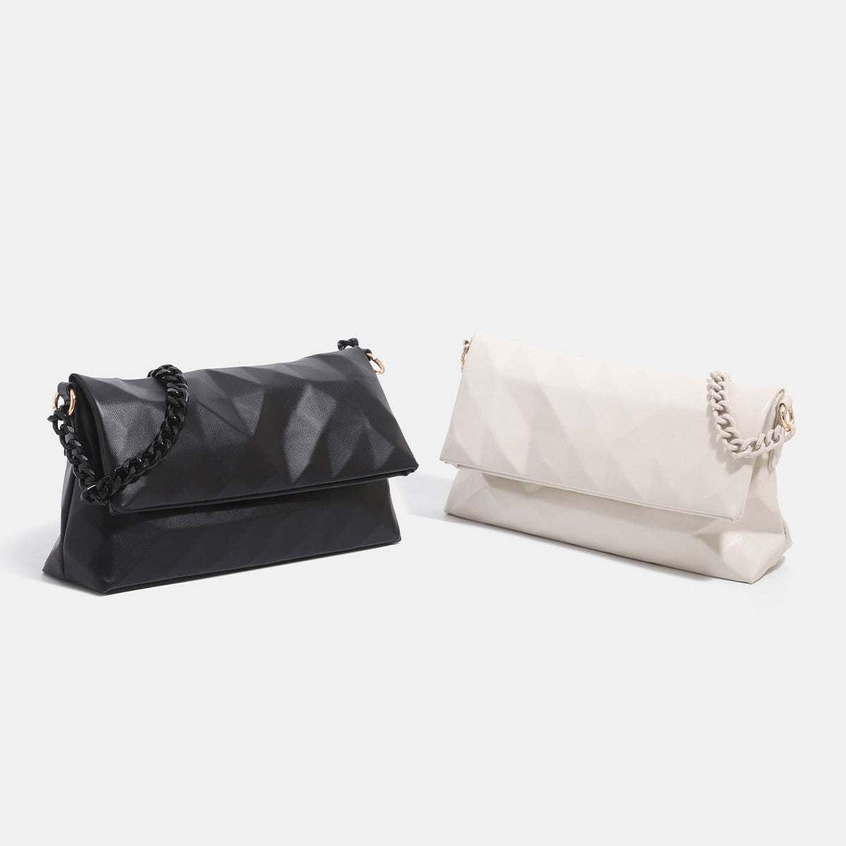 Geometric faceted flap shoulder bag with braided chain strap in black and ivory leather-look finish, detail view 2
