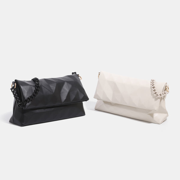 Geometric faceted flap shoulder bag with braided chain strap in black and ivory leather-look finish, detail view 2