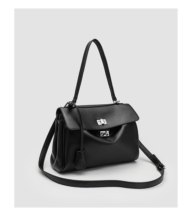 Structured black leather-look flap satchel bag with silver turn-lock hardware and top handle, detail view 15