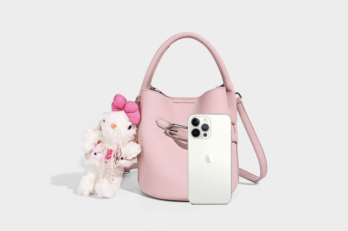 Mini pebbled leather-look bucket bag with front buckle strap, silver-tone hardware, top handle, and detachable shoulder