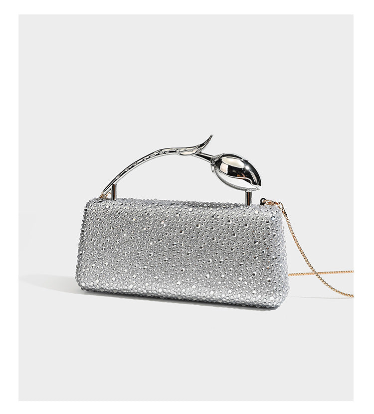 rectangular hard-case rhinestone evening clutch with sculptural gold-tone branch-and-bud top handle and detachable chain