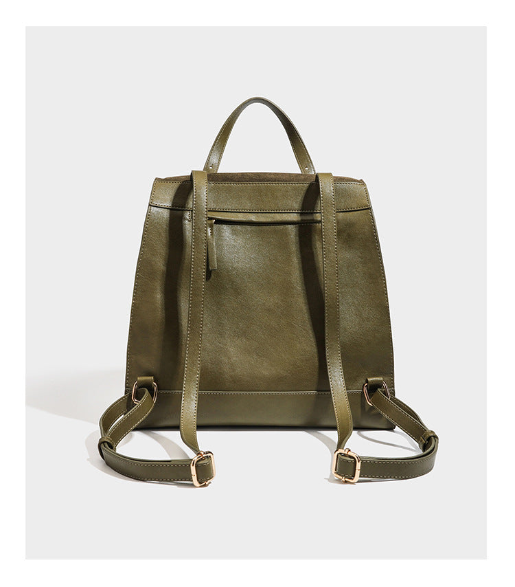 Structured suede-look convertible backpack handbag with flap closure and gold-tone emblem hardware in chocolate brown, detail
