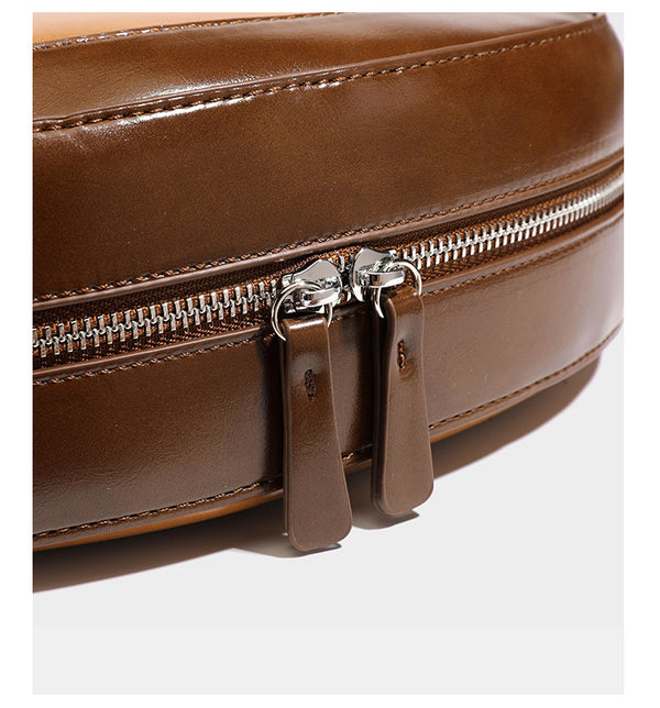 Glossy leather-look crescent hobo shoulder bag with dark contrast trim, silver-tone hardware, and attached mini flap pouch