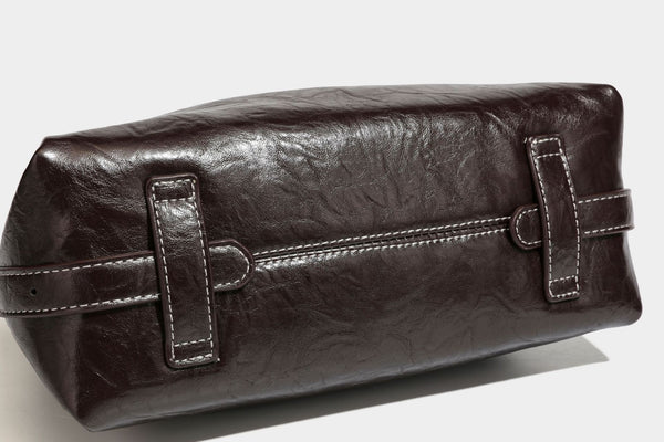 Slouchy hobo shoulder bag in glossy crinkled leather-look finish with zip-top closure and silver-tone ring hardware, detail