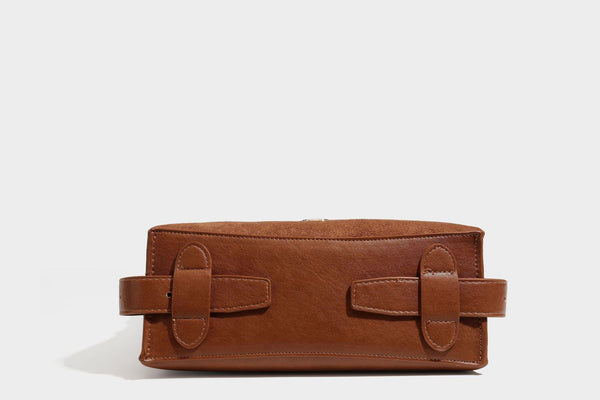Slouchy suede-finish brown shoulder bag with long single strap and small gold-tone logo emblem on front, detail view 28