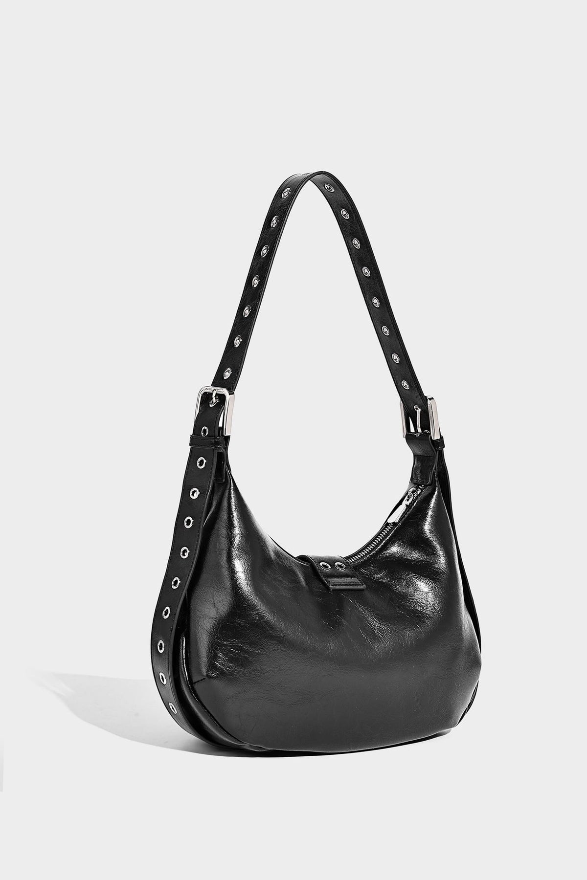 Glossy crescent hobo bag with silver-tone grommets, square buckle straps, and top zipper closure, detail view 19