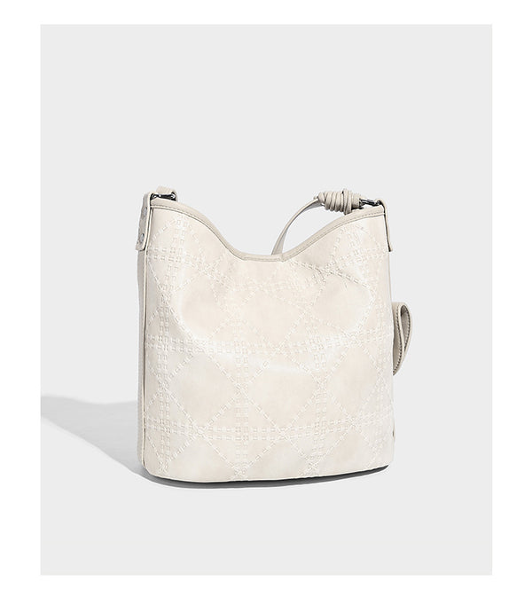 Diamond-quilted leather-look bucket shoulder bag with knotted strap accent and attached mini pouch, detail view 12