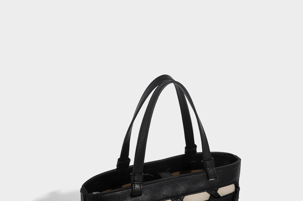 Structured woven lattice tote bag with cream lining, dual top handles, detachable crossbody strap, and silver-tone hardware