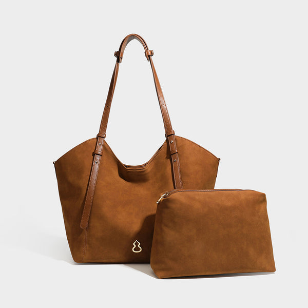 Oversized suede-finish tote shoulder bag in caramel brown with slim leather-look straps and gold-tone logo hardware, detail