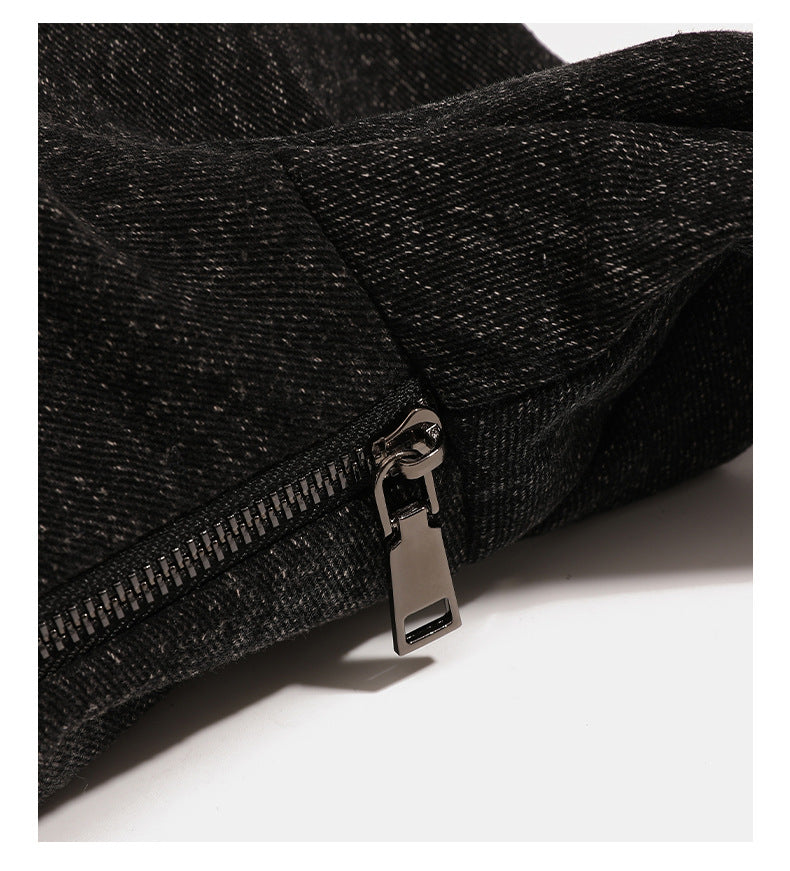 Oversized slouchy black textured canvas hobo shoulder bag with zip-top closure and adjustable dark-hardware strap, detail