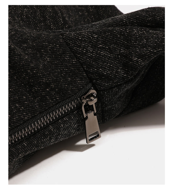 Oversized slouchy black textured canvas hobo shoulder bag with zip-top closure and adjustable dark-hardware strap, detail