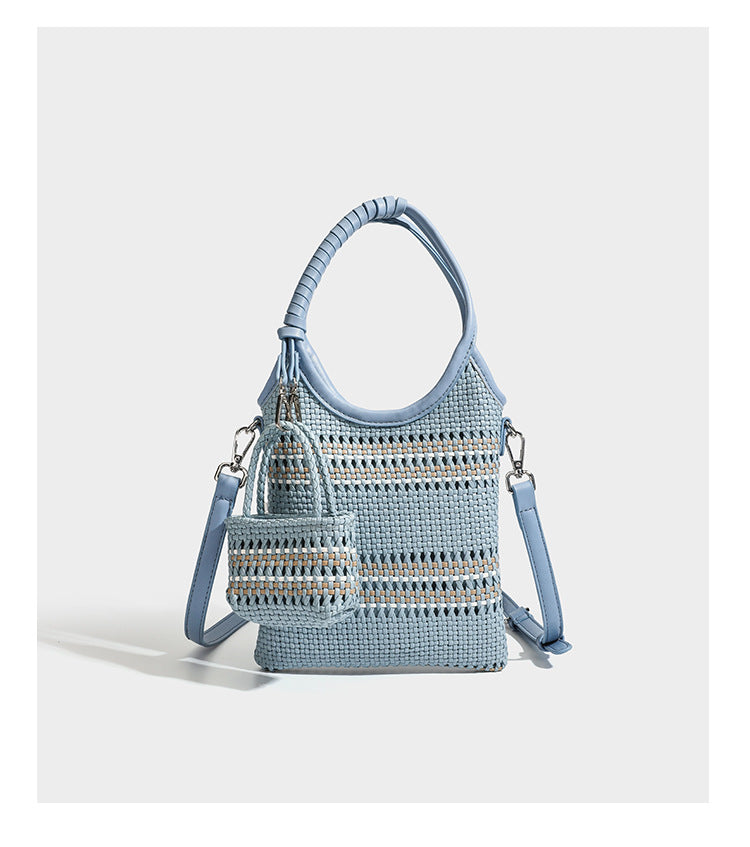 Brown two-tone woven leather-look shoulder bag with braided top handles, detachable mini pouch, and adjustable crossbody