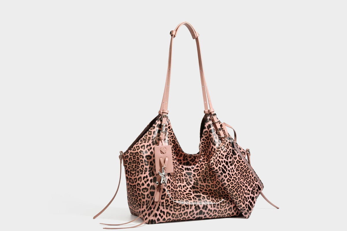 Large leopard print shoulder tote bag with glossy finish, long double straps, front zip pocket, silver-tone hardware, and