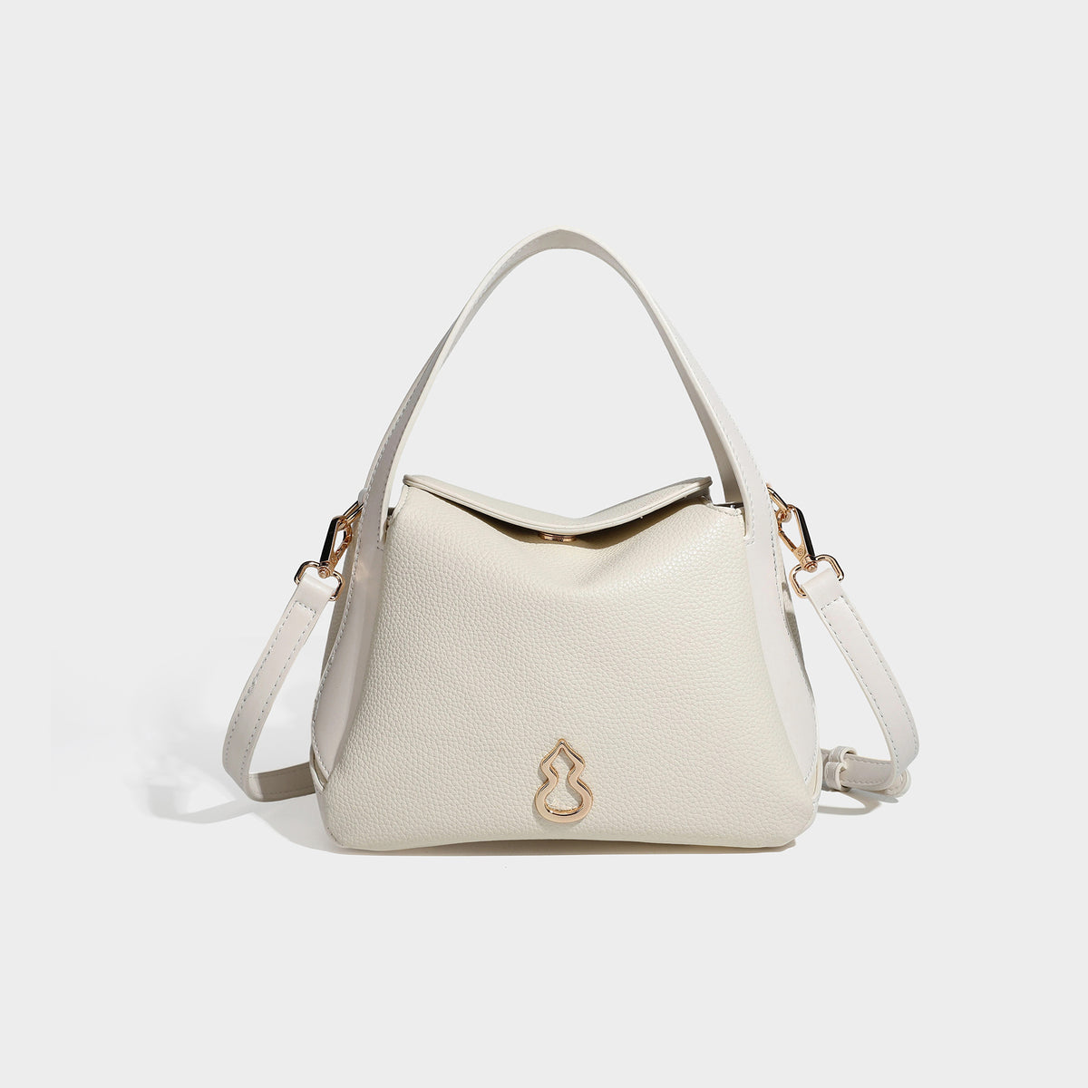 Structured pebbled leather-look shoulder bag with flap top, gold-tone emblem hardware, dual top handles, and detachable