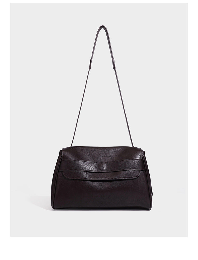 Structured rectangular flap shoulder bag in dark brown leather-look finish with long single strap and layered front panel