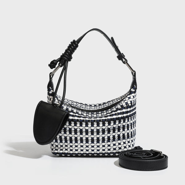 Small crescent shoulder bag in black-and-white woven textile with smooth black leather-look trim, zip-top closure, knotted