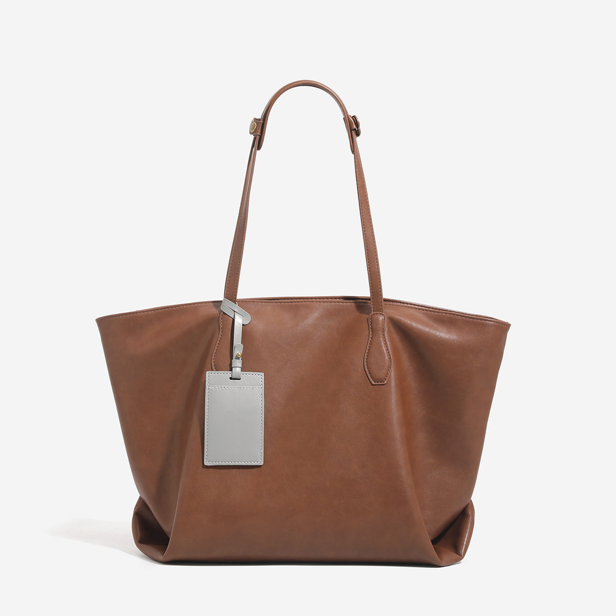 Large leather-look tote bag with trapezoid silhouette, double shoulder straps, and detachable hanging tag, detail view 8