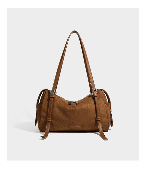 Large brown suede-finish barrel shoulder bag with dark leather-look trim, silver-tone zippers, dual top handles, and long