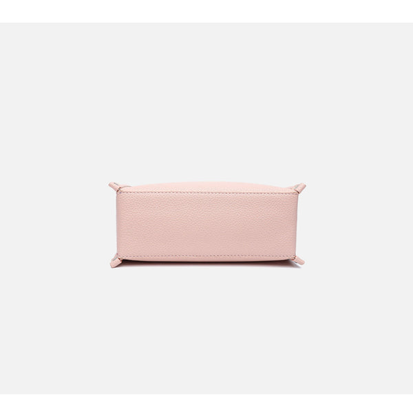 Small structured pebbled-finish convertible bag with silver corner studs, zip top, and detachable shoulder strap, detail view