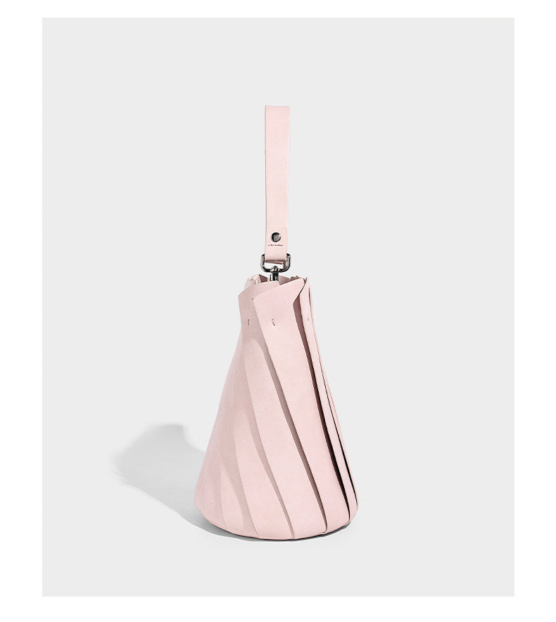 Structured pleated-panel bucket bag with curved top handle and detachable adjustable shoulder strap in smooth matte, detail