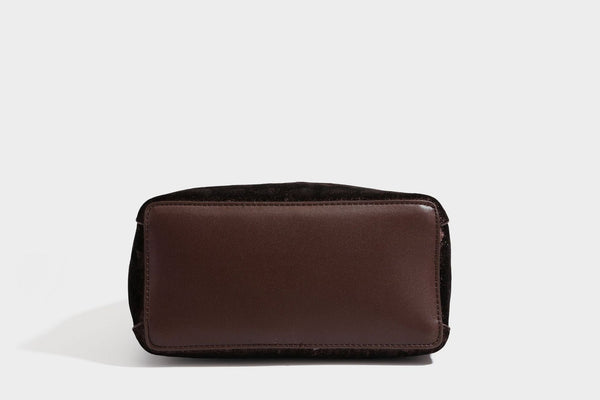 Small structured bucket satchel in embossed velvet-texture fabric with silver turn-lock hardware, rounded top handle, and