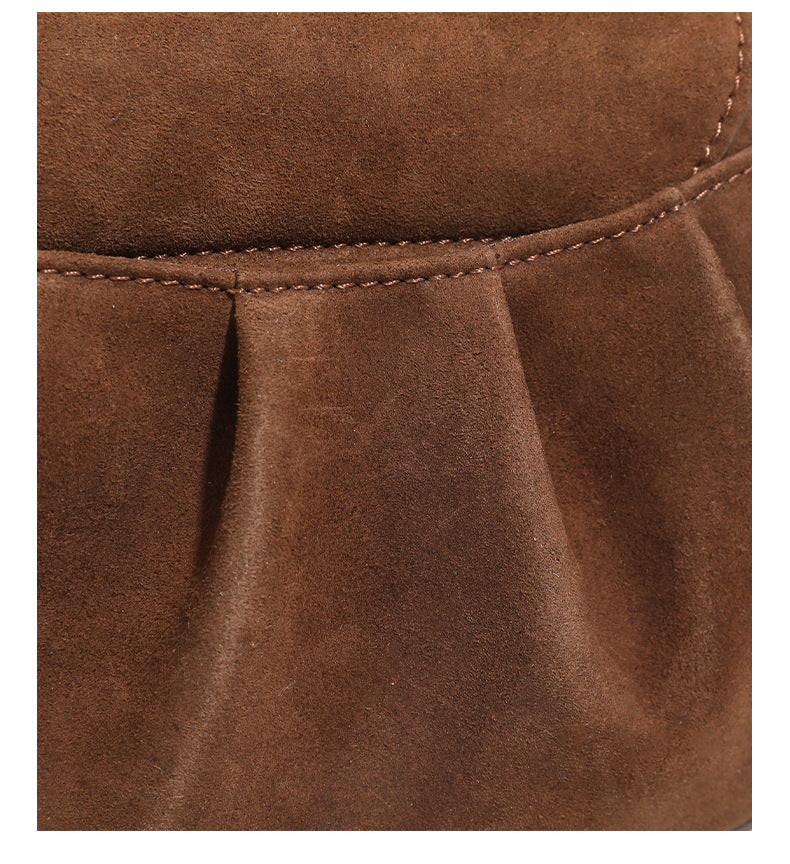 Small rounded flap crossbody saddle bag with gold-tone ring hardware and adjustable strap, detail view 14