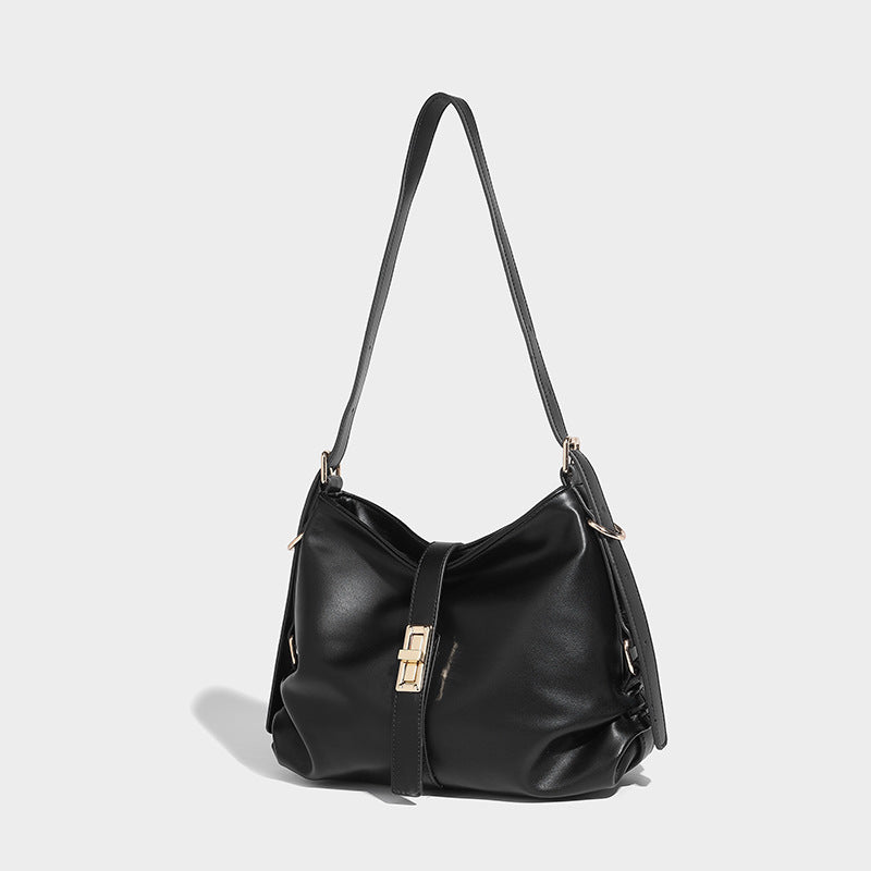 Soft slouchy hobo shoulder bag with smooth leather-look finish, gold-tone buckle and tab hardware, and long adjustable strap