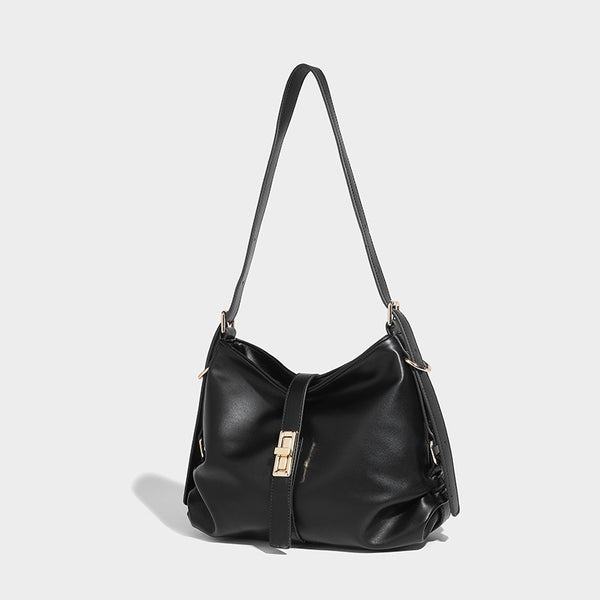 Soft slouchy hobo shoulder bag with smooth leather-look finish, gold-tone buckle and tab hardware, and long adjustable strap