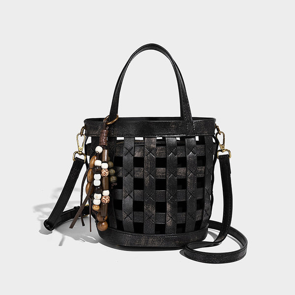 Small woven lattice bucket bag in brown leather-look finish with beaded tassel charm, dual top handles, and detachable