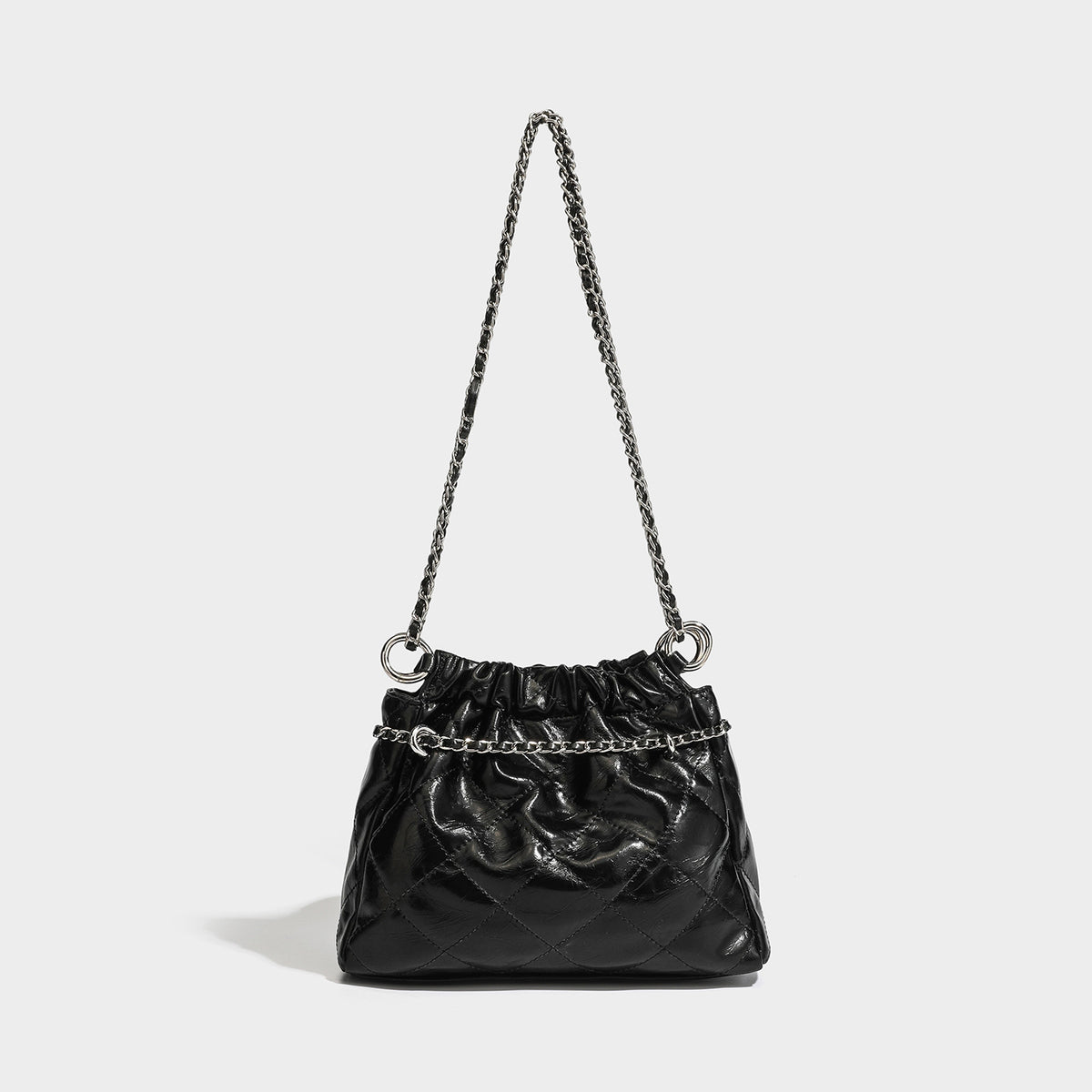 Glossy diamond-quilted drawstring bucket bag with silver chain shoulder strap and medallion charm, detail view 3