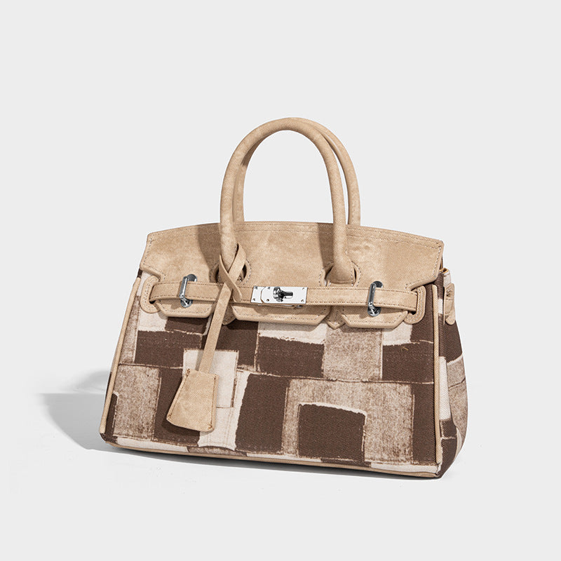 Structured patchwork satchel bag with double top handles, turn-lock flap closure, and silver-tone hardware, front view