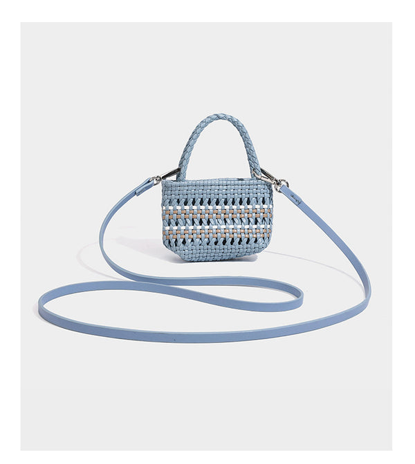 Structured woven bucket tote bag in pastel blue with braided shoulder strap, open lattice weave body, cream drawstring