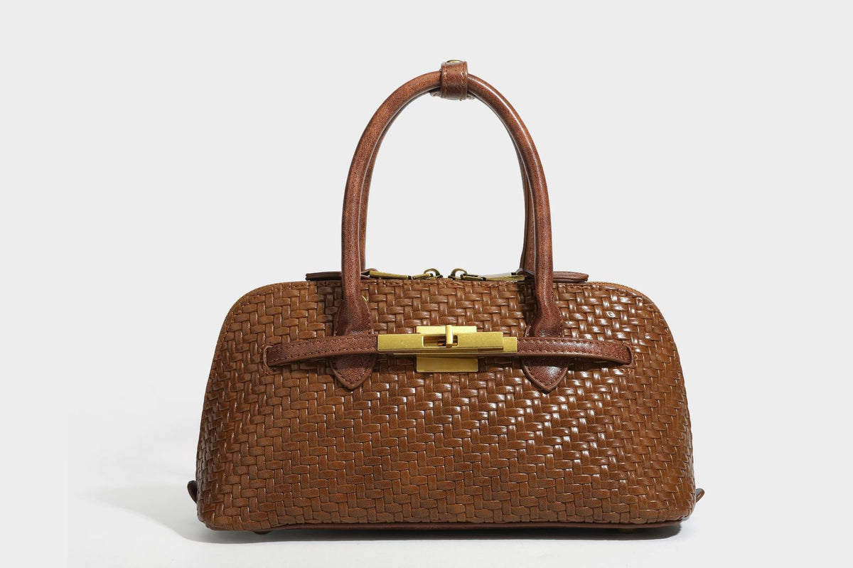 Structured woven-embossed leather-look satchel with dual rolled top handles, gold-tone turn-lock closure, and detachable