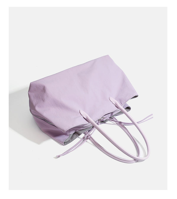 Large soft nylon tote bag with long double handles and zippered top in lavender, detail view 12
