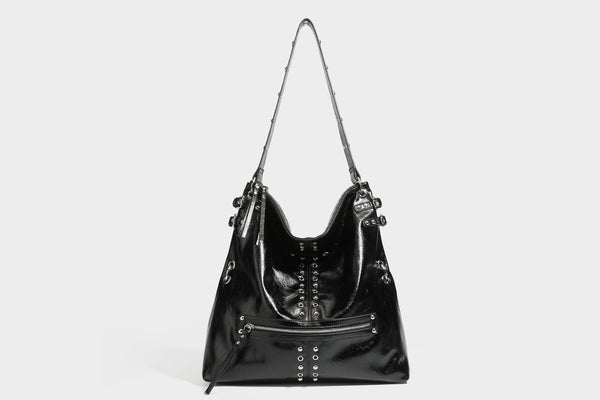 Black glossy leather-look slouchy shoulder bag with silver stud and eyelet hardware, top zip closure, front zip pocket, and