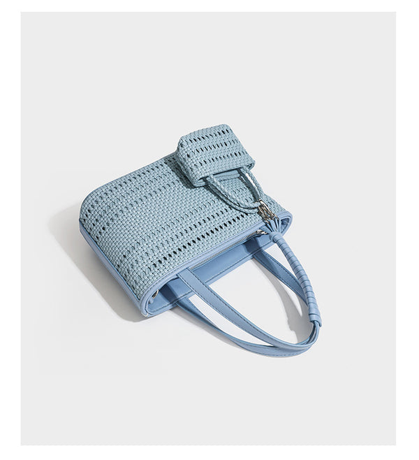 Structured open-weave tote bag with smooth leather-look trim, double top handles, detachable crossbody strap, and mini zip