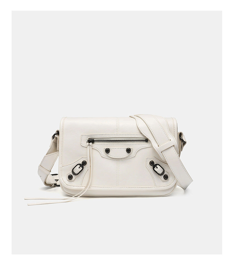 Small structured rectangular crossbody bag with crinkle leather-look finish, front zip pocket, gunmetal stud hardware, and