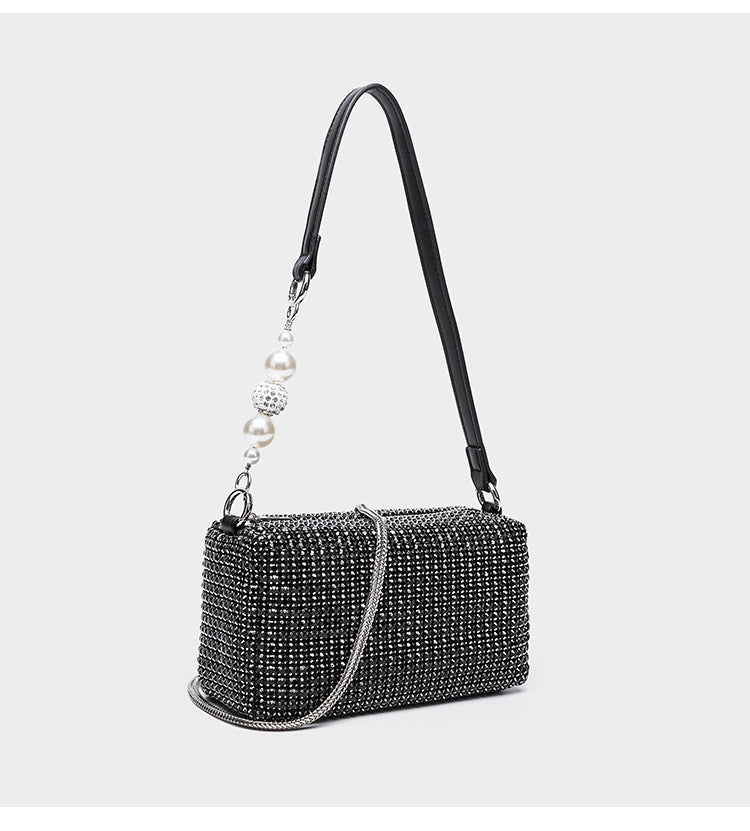 Small rectangular all-over rhinestone crossbody bag with pearl bead zipper pull and detachable silver chain strap, detail