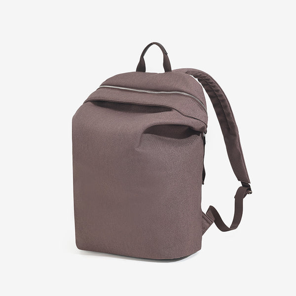 Structured matte nylon backpack with top zip closure, front zip pocket, top carry handle, and adjustable shoulder straps