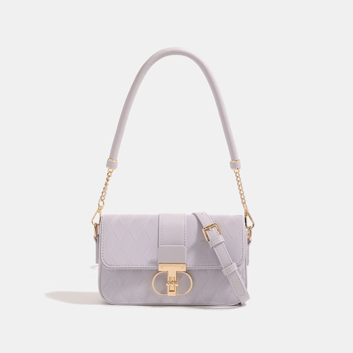 Compact quilted flap crossbody bag with gold turn-lock clasp and adjustable shoulder strap, front view
