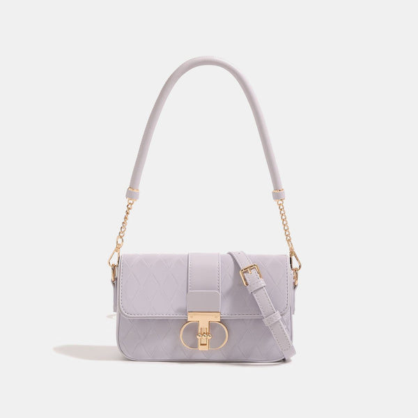 Compact quilted flap crossbody bag with gold turn-lock clasp and adjustable shoulder strap, front view