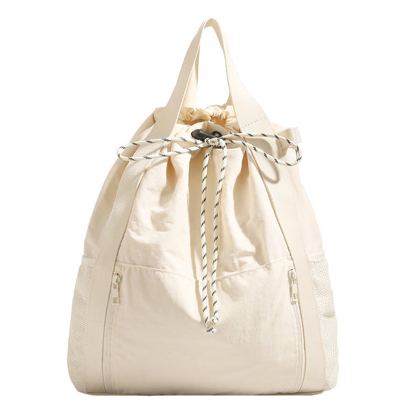 Soft matte drawstring backpack tote with braided cord closure, front zip pocket, and mesh side panels, detail view 5